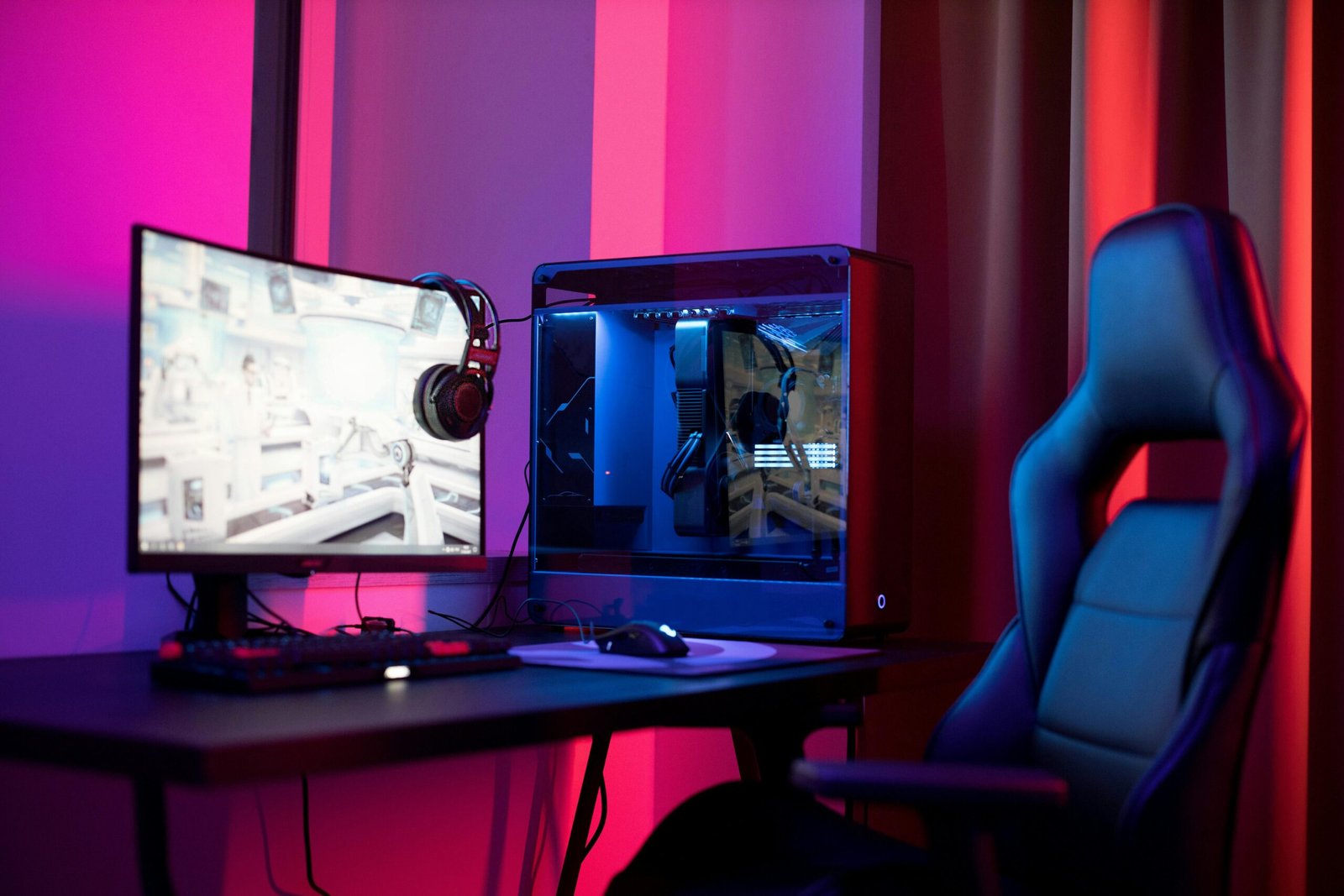 modern gaming computer setup with RGB lighting, streaming equipment, professional microphone, multiple monitors